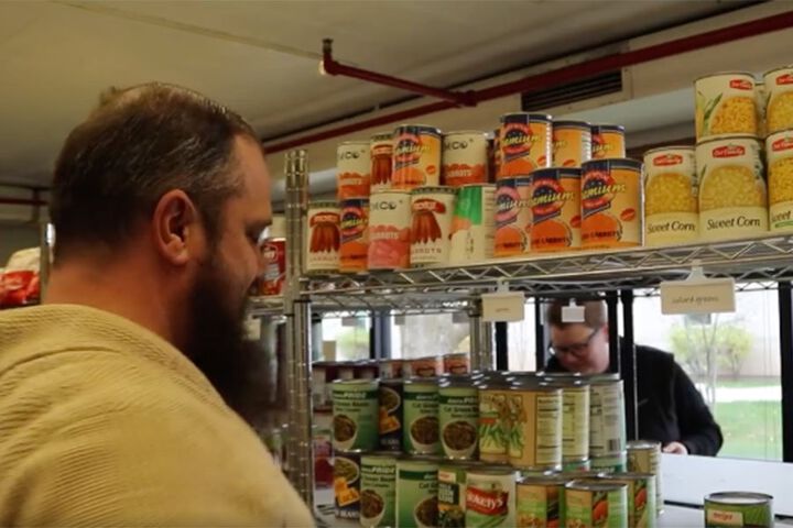 Workers stock shelves at the Titans Feeding Titans food pantry.
